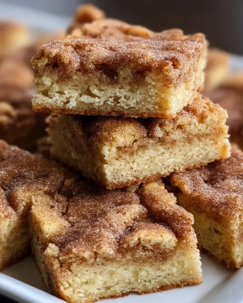 Chewy snickerdoodle cookie bars with cinnamon sugar topping
