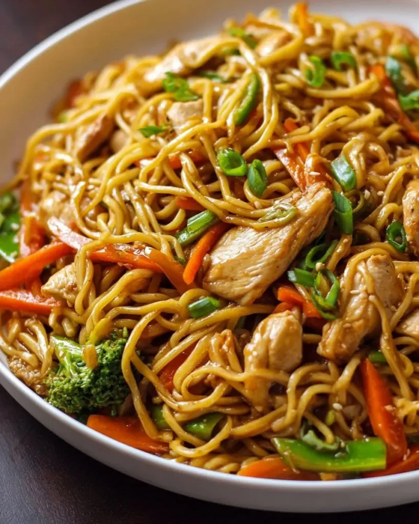 A plate of easy chicken lo mein with colorful vegetables and noodles.