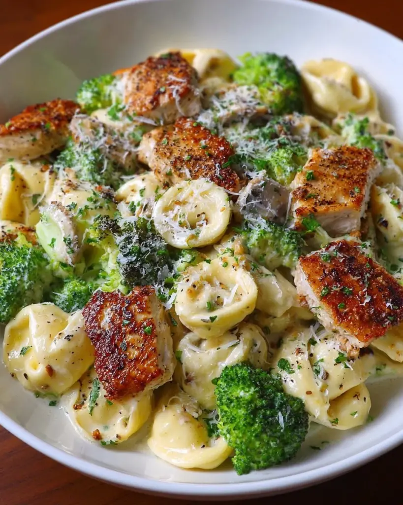 Creamy Tortellini Alfredo topped with parsley and parmesan cheese