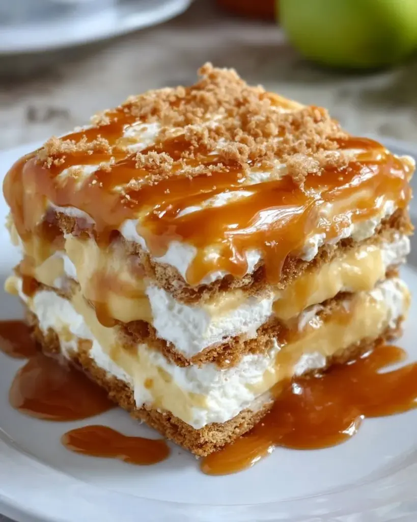 Delicious Caramel Apple Eclair Cake with caramel drizzle and apple slices.